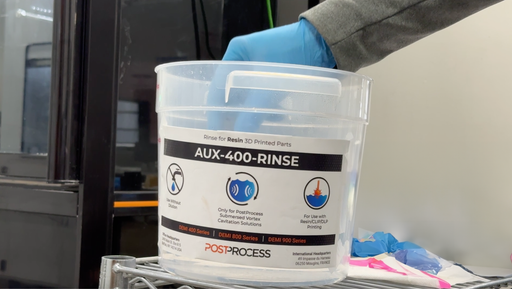 Image shows AUX-400-RINSE drum of detergent for removing excess of resin  in the post-processing step