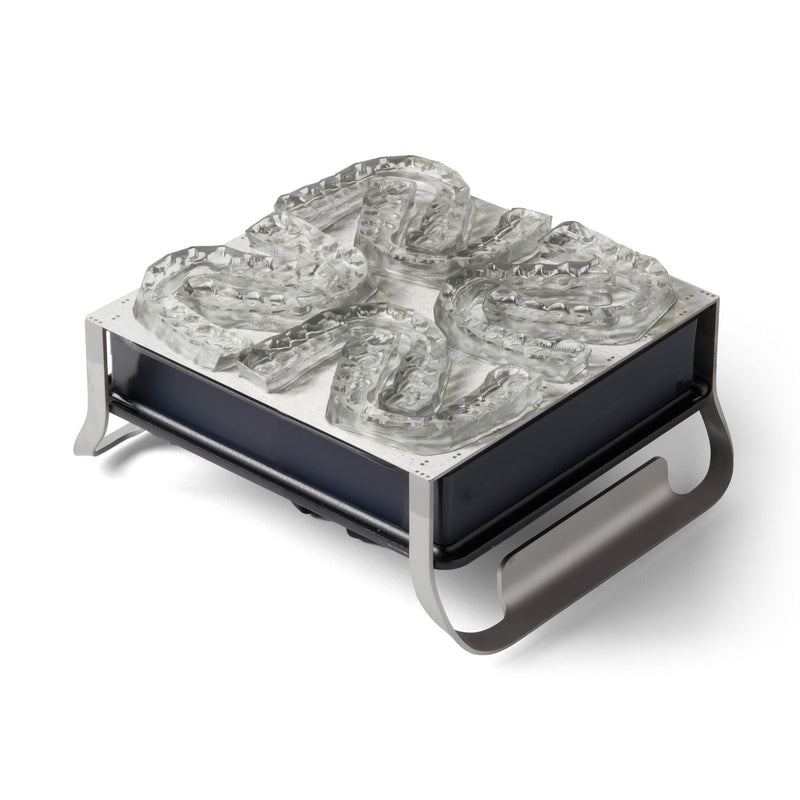 Image shows Form 3B build platform with dental bonding trays 3D printed IBT Flex Photopolymer material