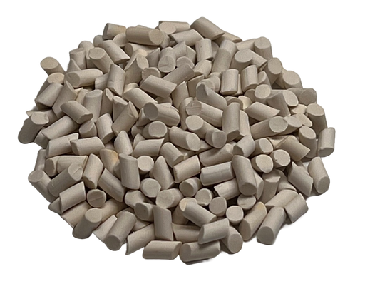 Image shows a pile of small porcelain polishing surface finish media from PostProcess