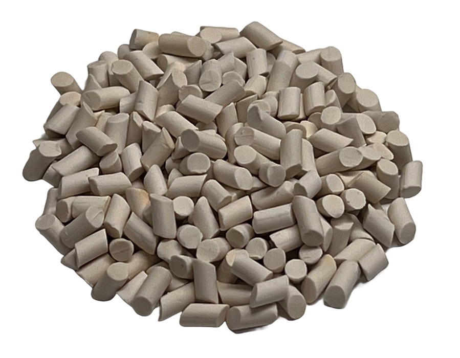 Image shows a pile of small porcelain polishing surface finish media from PostProcess