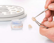 Image shows dental technician applying VITA AKZENT Plus Effect Stains Paste on a tooth