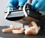 Image shows 3D printed dentures being easily removed from Formlabs Build Platform 2  - Proto3000 Online Store 